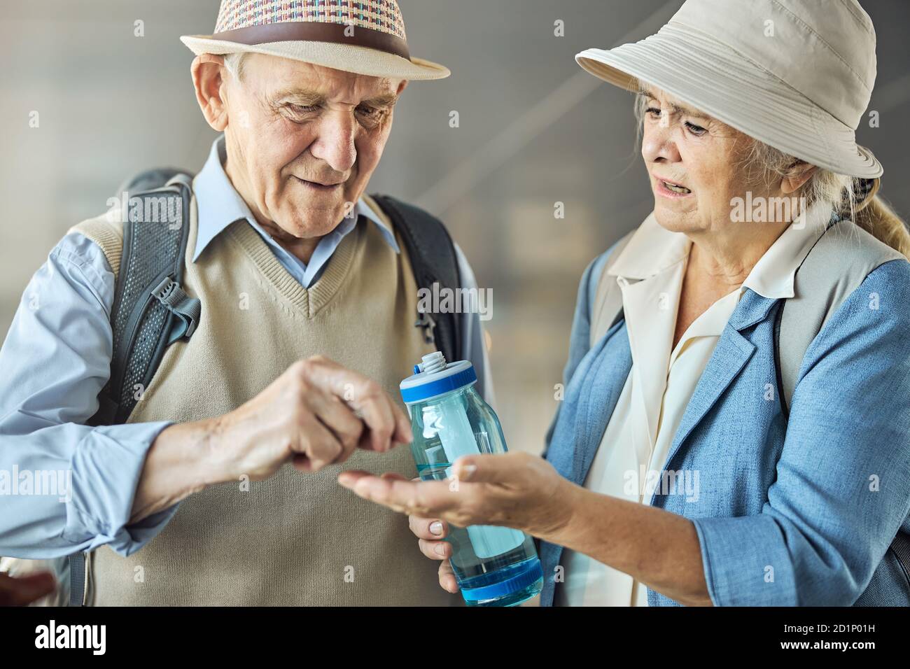 Male tourist taking a medicine from his worried spouse Stock Photo