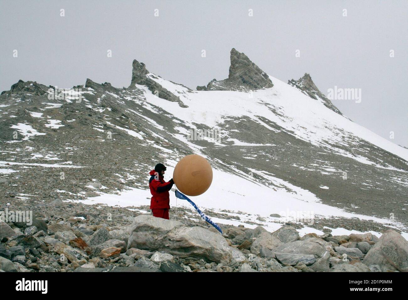 A Norwegian scientist fills a weather balloon on the Trollveikja mountainside in Antarctica, a sector claimed by Norway about 250 km (155 miles) from the sea, January 19, 2008. Nations claiming parts of Antarctica are quietly staking out rights to the seabed, in stark contrast to the North Pole where Russia ostentatiously planted a flag to back its claim. Picture taken January 19, 2008. To match feature ANTARCTICA/CLAIMS  REUTERS/Alister Doyle    (ANTARCTICA) Stock Photo