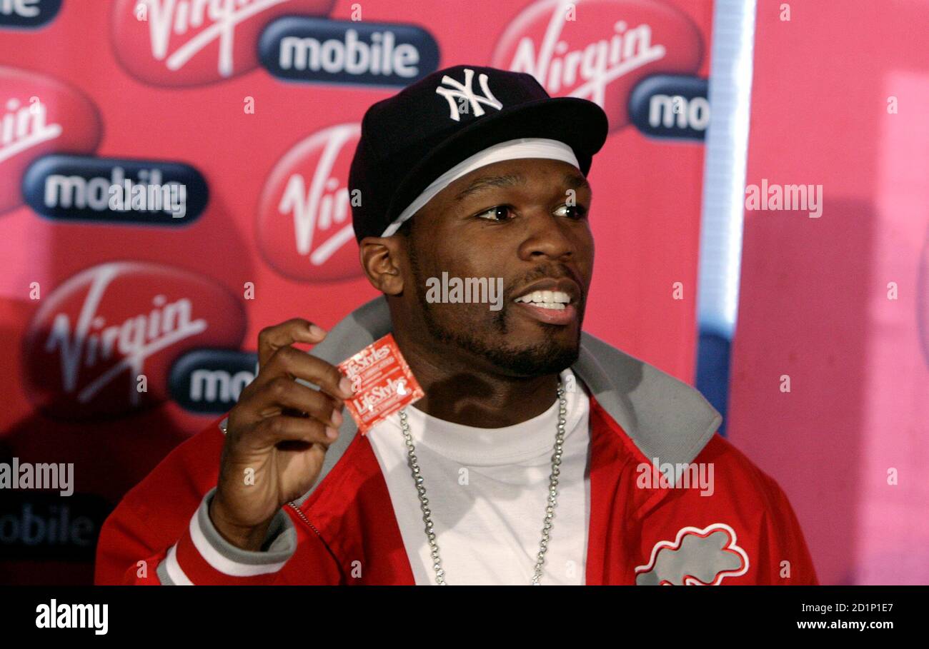 Rapper 50 Cent From The U S Holds Up A Condom During A Media Briefing At Lanseria Airport Outside Johannesburg April 30 08 50 Cent Together With His G Unit Crew Will Perform Twice