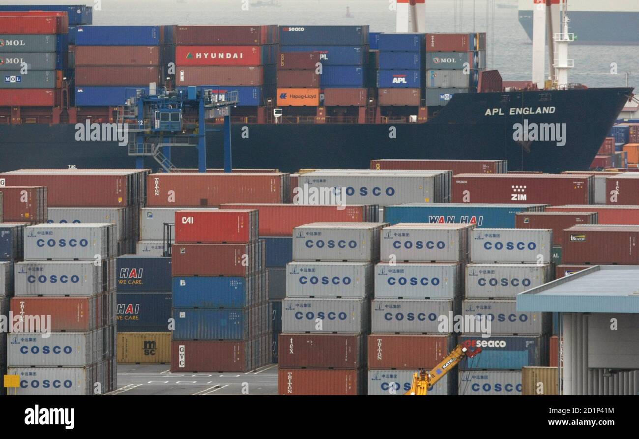 A Cargo Ship Is Seen Between Containers At A Pier Of Cargo Area At A Port In Yokohama South Of Tokyo December 22 08 Japan S Exports Plunged At A Recordannual Pace In