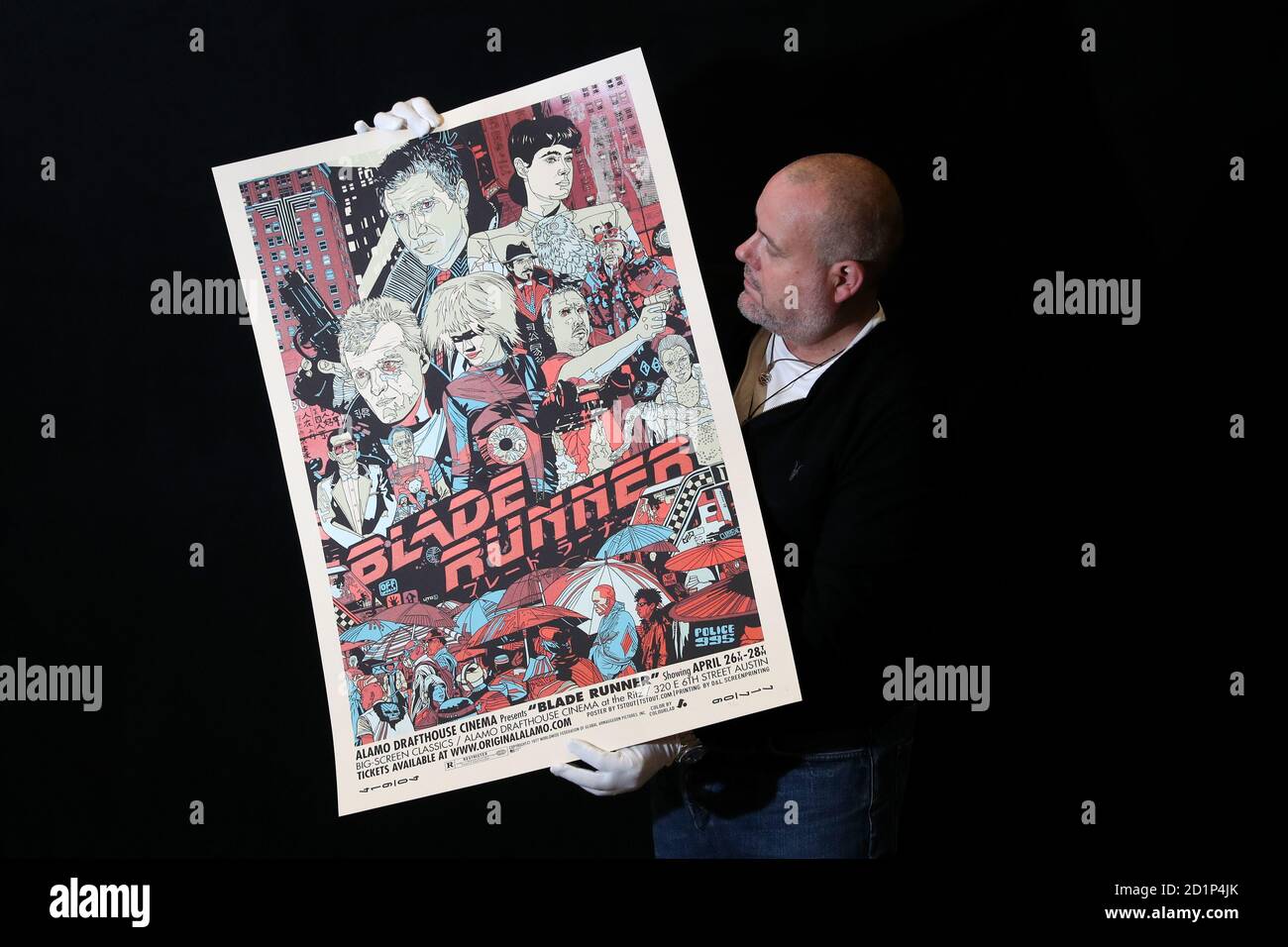 Prop Store poster consultant Mark Hochman holds a Mondo poster for the 1982 film 'Blade Runner' (estimate £1-2k) during a preview for the forthcoming cinema poster auction by the Prop Store in Chorleywood, Hertfordshire. Stock Photo