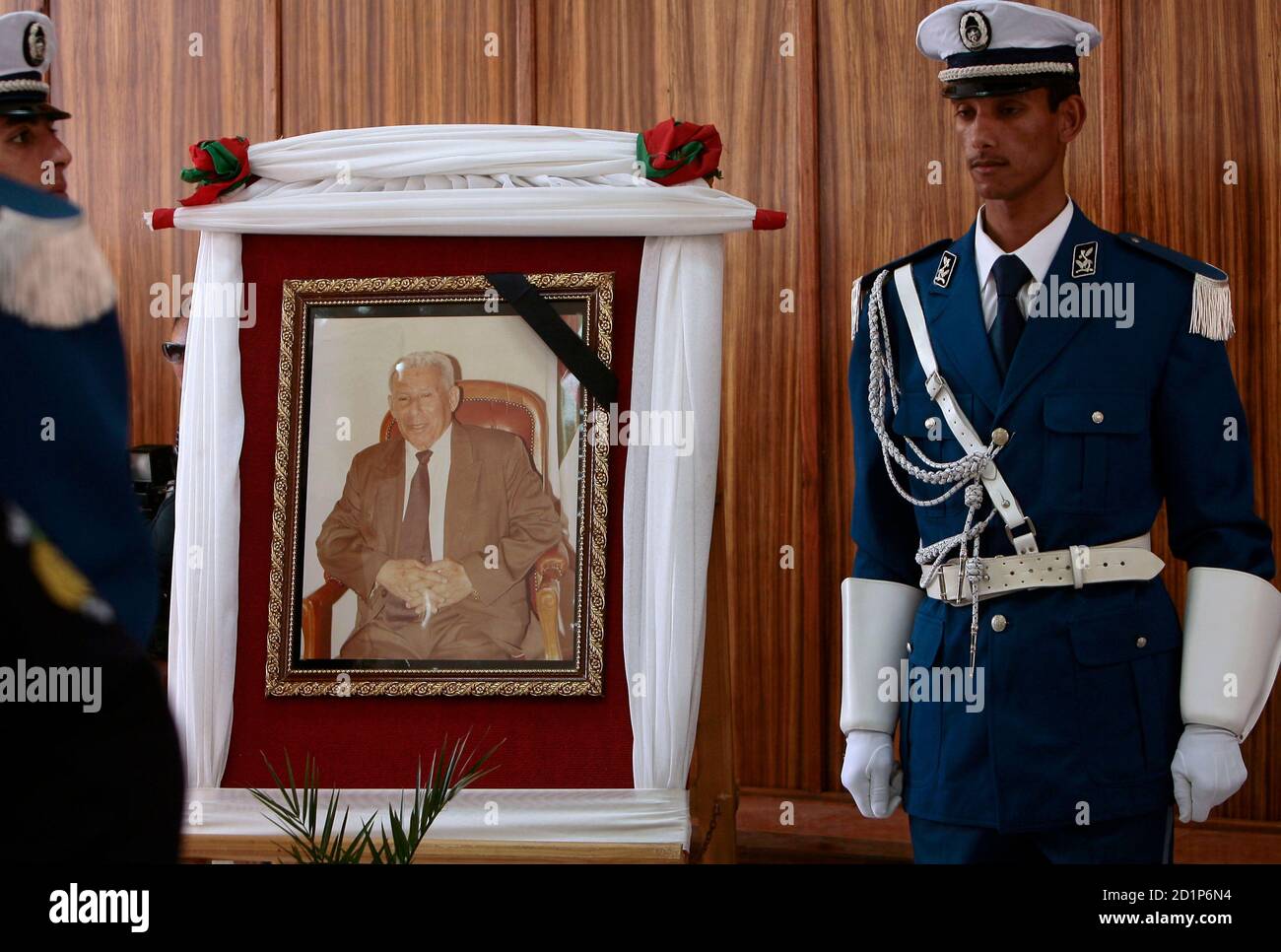 An Algerian policeman stands at attention near a portrait of national police chief Ali Tounsi at a ceremony to pay the last tribute at the police training academy in Algiers February 26,