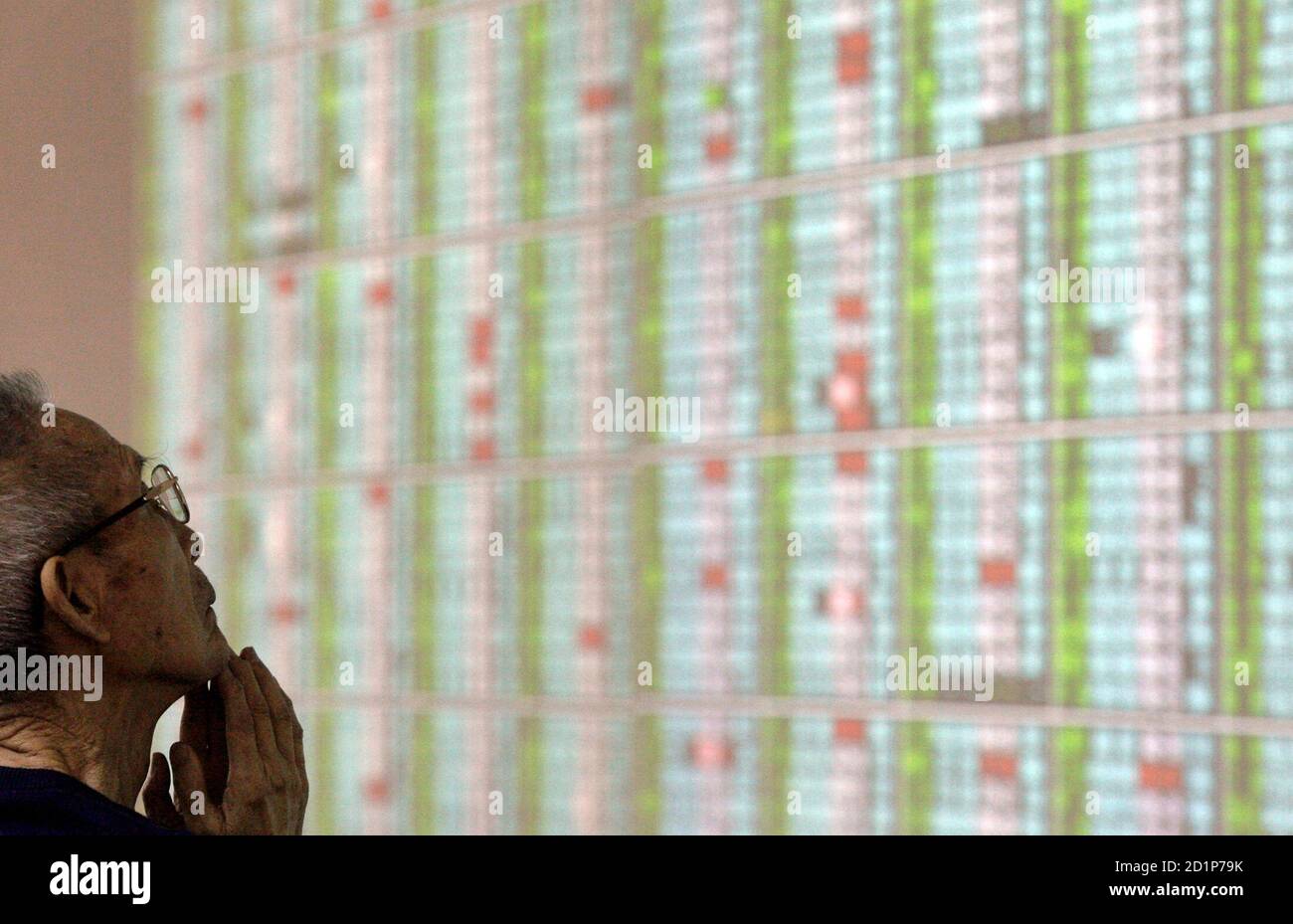 A person gestures while monitoring stock market prices inside a securities bank in Taipei May 7, 2010. Taiwan stocks fell 0.16 percent on Friday to a more than two-month closing low, dragged down by worries over a European credit crunch and a slump in Wall Street, but analysts say state funds stepped in to prop up prices.   REUTERS/Pichi Chuang (TAIWAN - Tags: BUSINESS) Stock Photo
