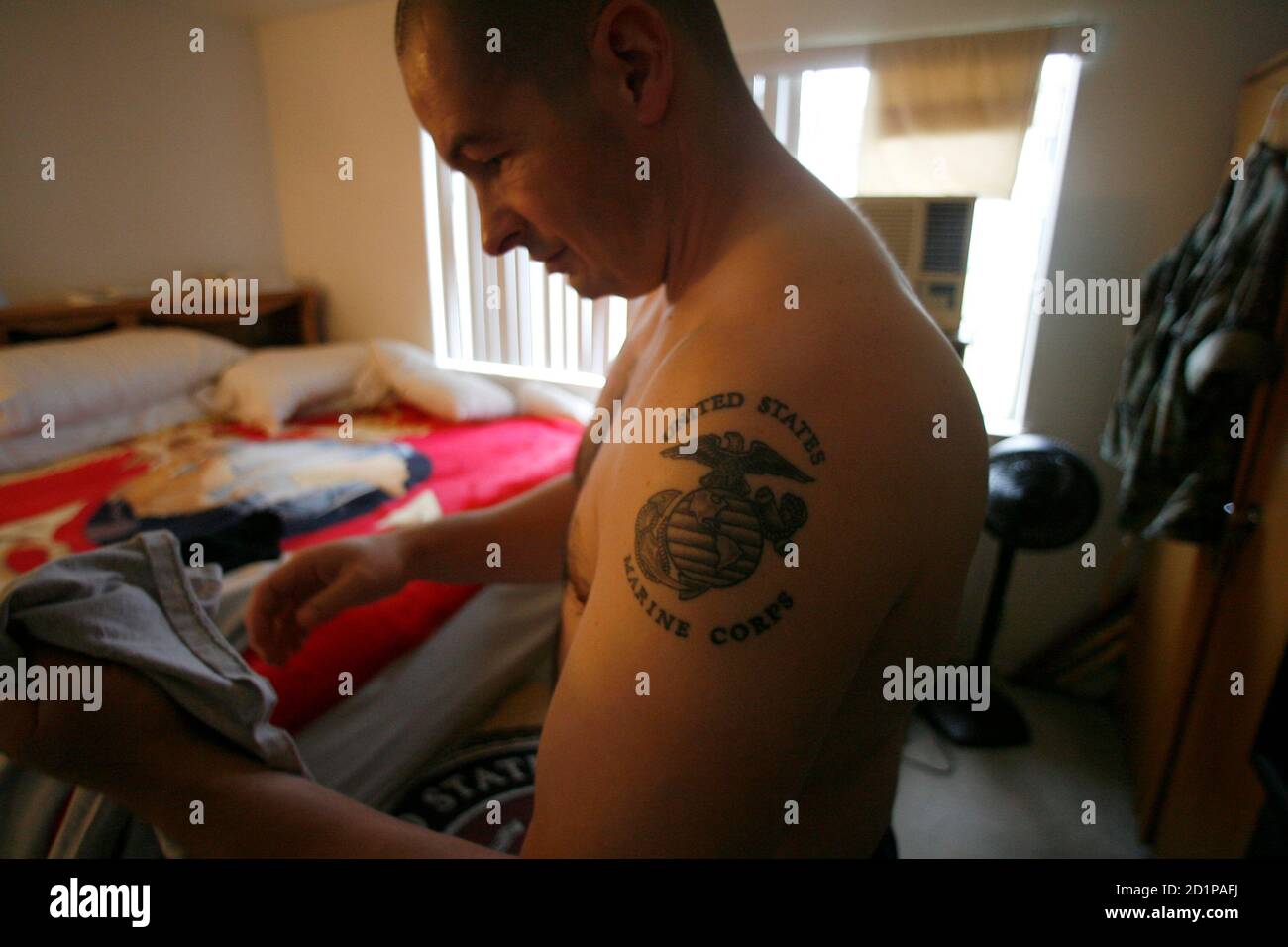 Iraq war veteran Ken Sargent gets dressed at his home in the early morning hours of March 14, 2007. On August 5, 2004, a bullet erased most of Sargent's vision and blew two inches off the left side of his brain, destroying parts of his memory and mental function. Picture shot March 14, 2007. REUTERS/Mike Blake  (UNITED STATES) Stock Photo
