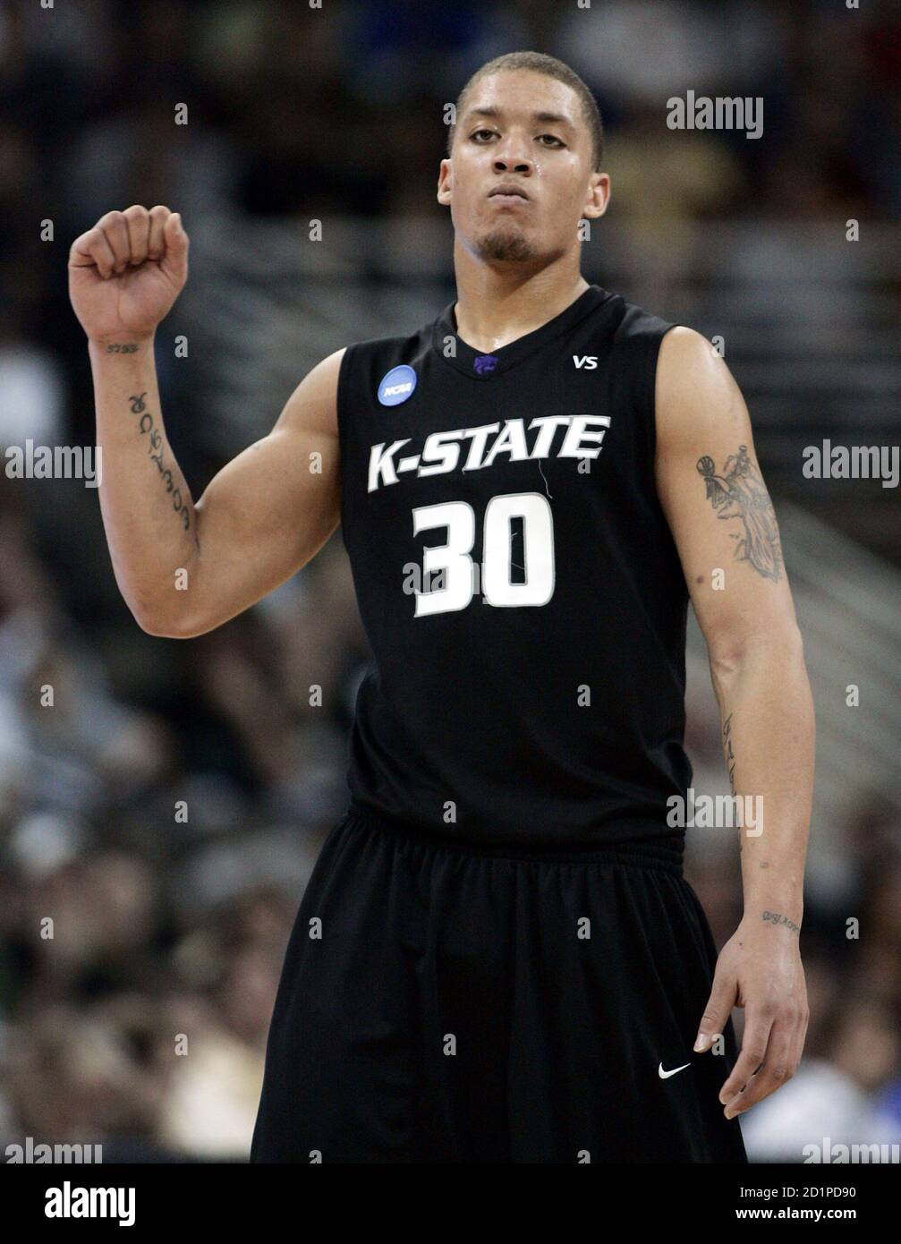 Michael Beasley of the Kansas State Wildcats pumps his fist after beating  the USC Trojans during their first round NCAA men's basketball championship  game in Omaha, Nebraska, March 20, 2008. The Wildcats