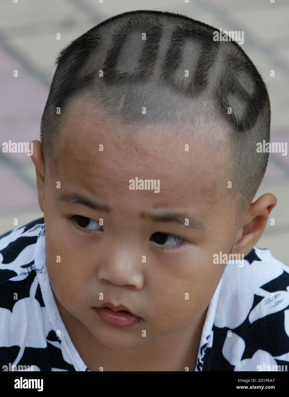 A boy with a Beijing 2008 Olympic hair cut plays at a community centre in Beijing August 2, 2008. Hair stylist Wu Dasheng has cut the hair of 29 children with Beijing A boy with a Beijing 2008 Olympic hair cut plays at a community centre in Beijing August 2, 2008. Hair stylist Wu Dasheng has cut the hair of 29 children with Beijing