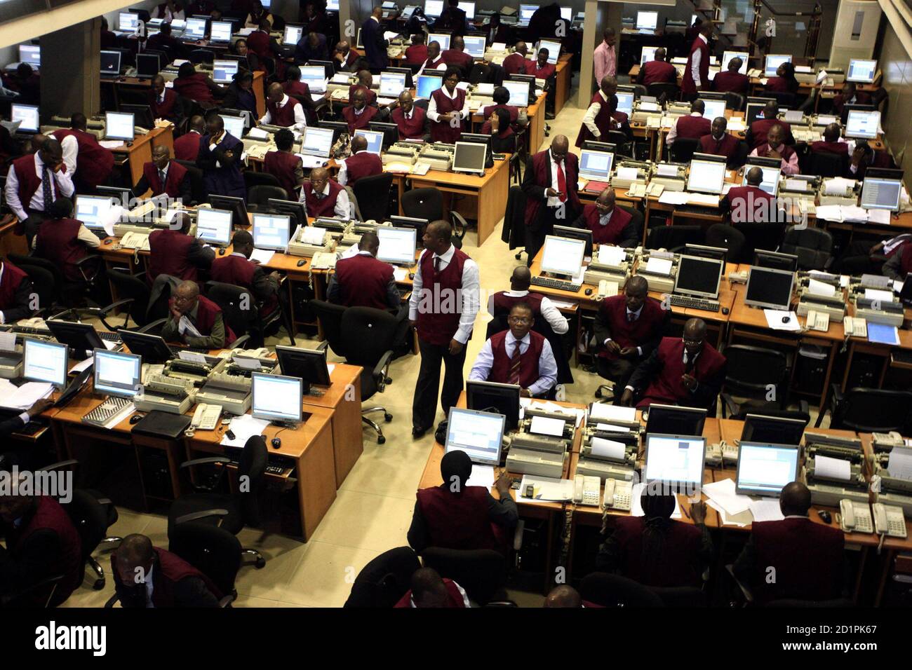 Brokers work on the trading floor of the Nigerian stock exchange in the commercial capital Lagos April 28, 2010. Nigeria's FinBank said on Wednesday its 2009 pre-tax loss widened by 38 percent to 111.23 billion naira ($742 million) due partly to provisioning for risk assets. Gross earnings at Finbank, one of those rescued in a $4 billion sector bailout last year, rose 135 percent to 72.4 billion naira during the period, the bank said in a filing to the Nigerian Stock Exchange.      REUTERS/Akintunde Akinleye(NIGERIA - Tags: BUSINESS) Stock Photo