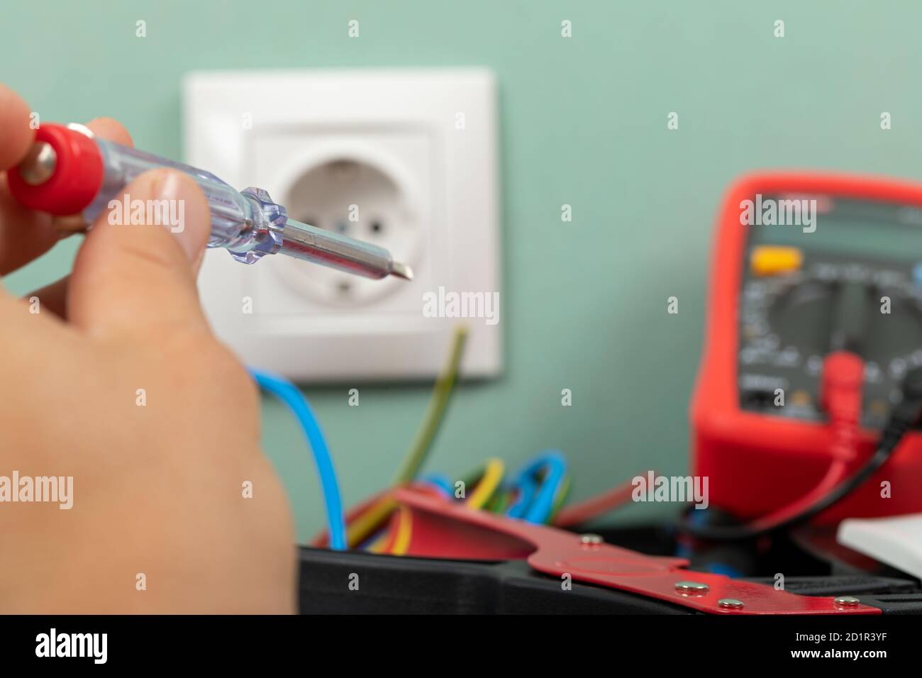 Tools for electrician needs: multimeter, voltage testers, wire strippers, pliers, Stock Photo