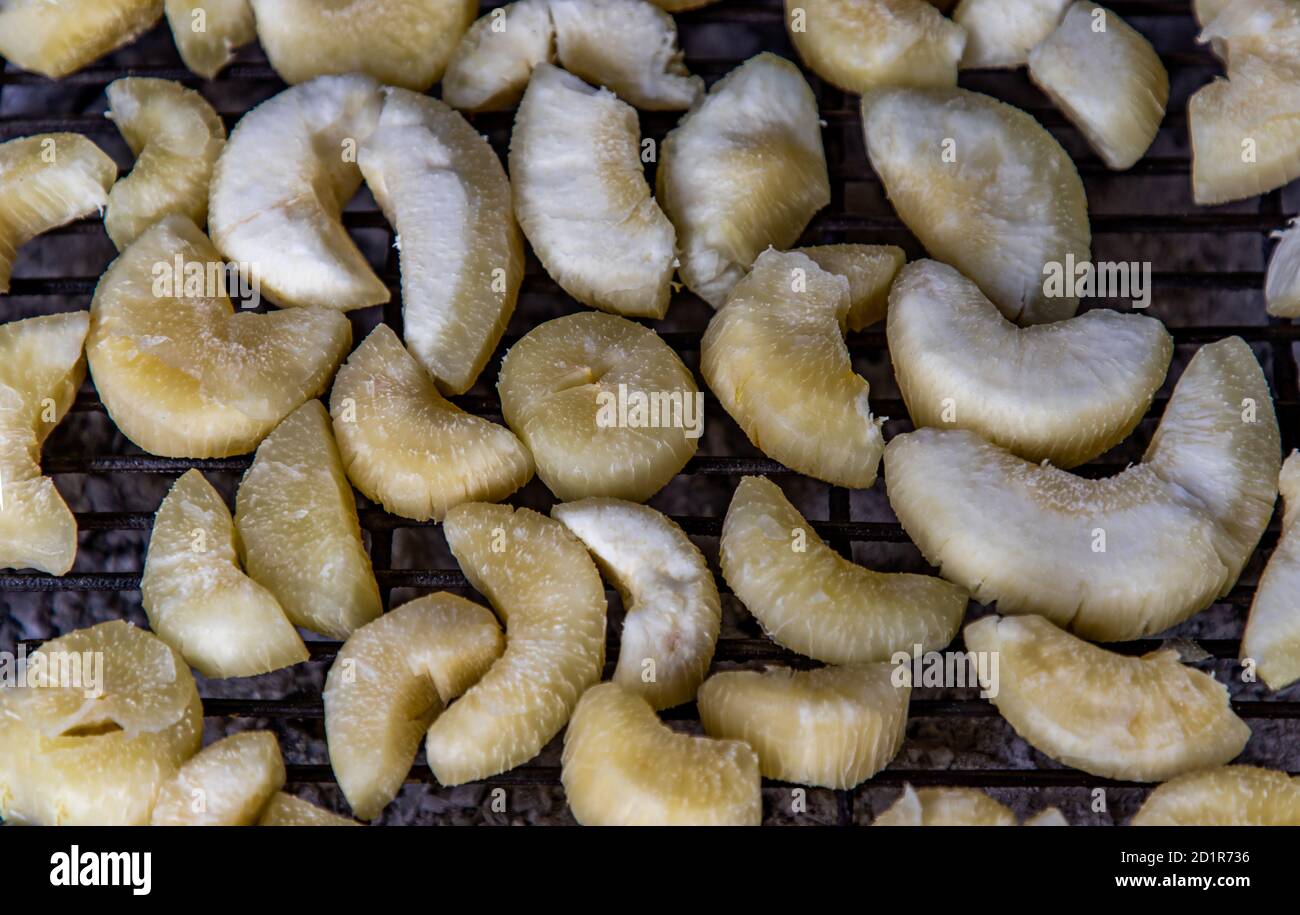 Tapioca or cassava roasted on charcoal stove at Street food. Healthy food. Top view, Selective focuse. Stock Photo