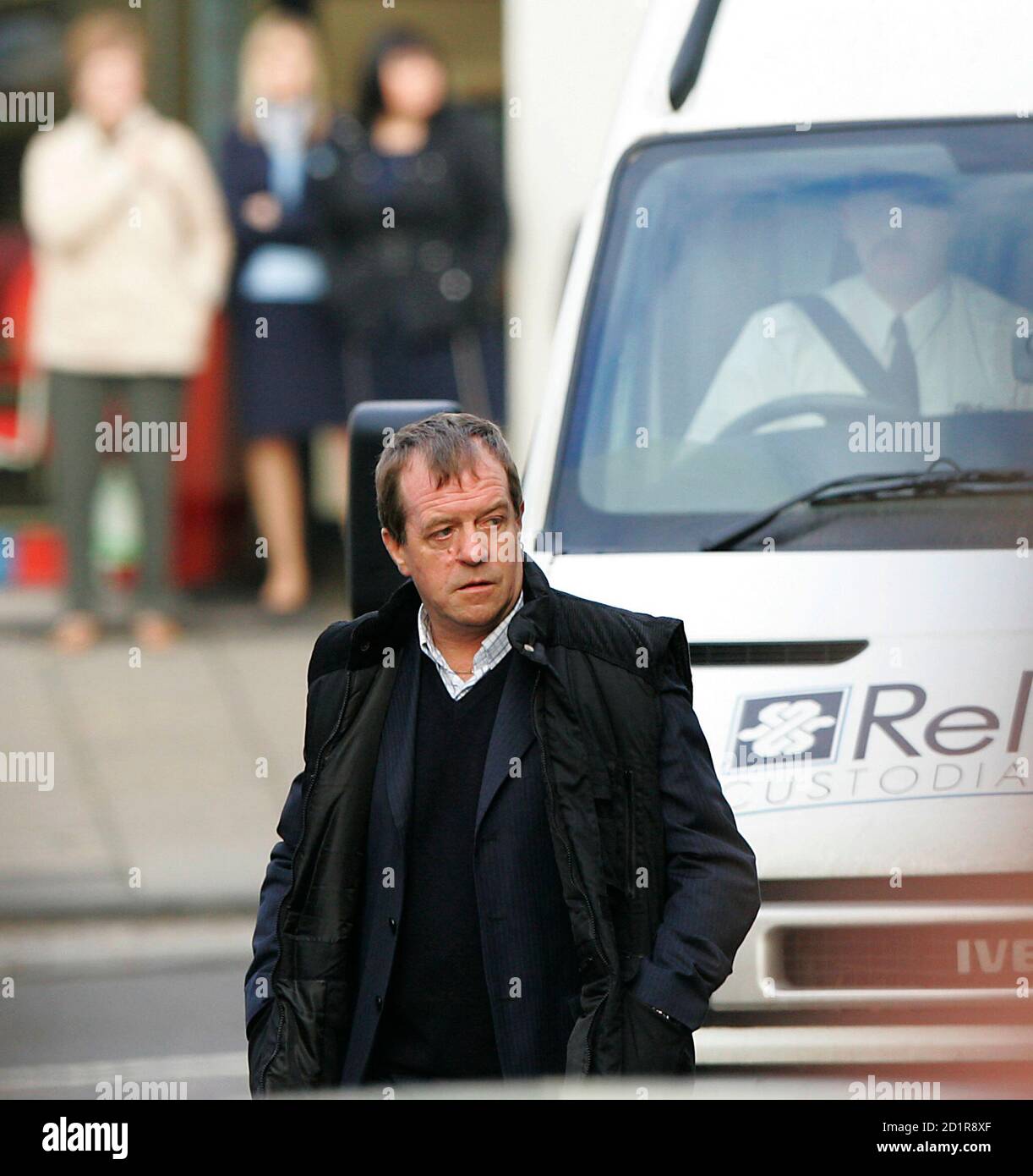 Michael Hamilton, the father of missing girl Vicky Hamilton, walks in front of the prison van carrying Peter Tobin, who is accused of killing Vicky, as it arrives at Linlithgow Sherriff Court, central Scotland November 15, 2007.  Tobin appeared in court on Thursday charged with murdering the teenage girl whose remains were found in a house in Kent, 16 years after she vanished from her home.      REUTERS/David Moir (BRITAIN) Stock Photo