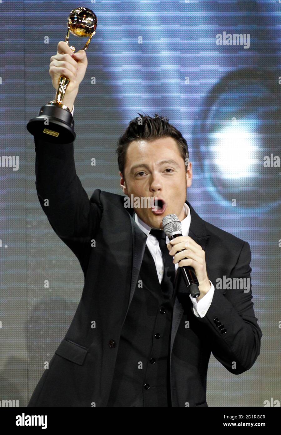 Italian singer Tiziano Ferro holds up his Best Selling Artist from Italy  award during the World Music Awards in Monte Carlo May 18, 2010. The World  Music Awards honours the bestselling recording