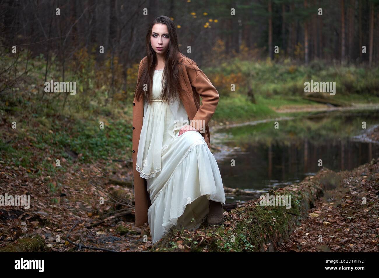 girl in a white dress and a brown coat in the autumn forest Stock Photo ...
