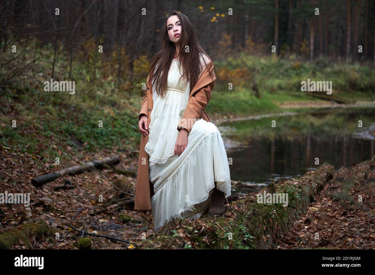 girl in a white dress and a brown coat in the autumn forest Stock Photo ...