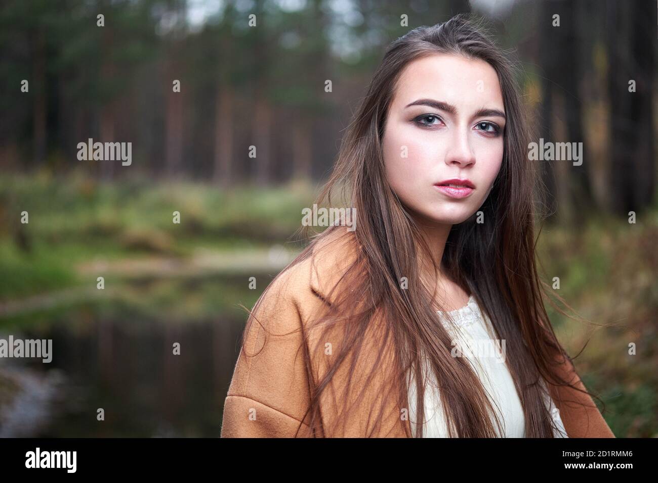girl in a white dress and a brown coat in the autumn forest Stock Photo ...