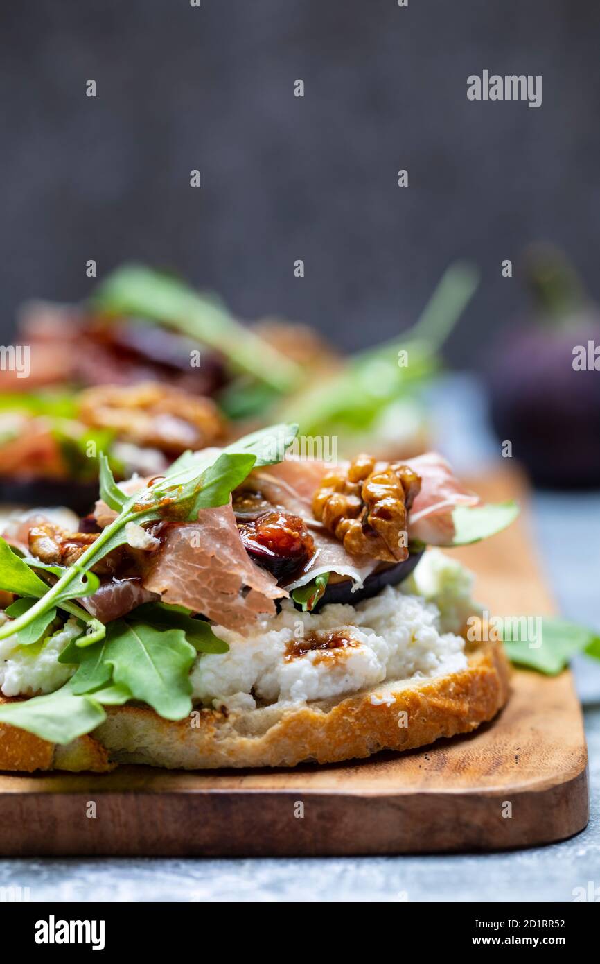 Canapes with ricotta cheese, figs, walnuts and parma ham Stock Photo ...