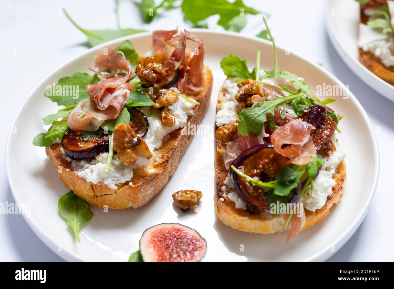 Canapes with ricotta cheese, figs, walnuts and parma ham Stock Photo ...