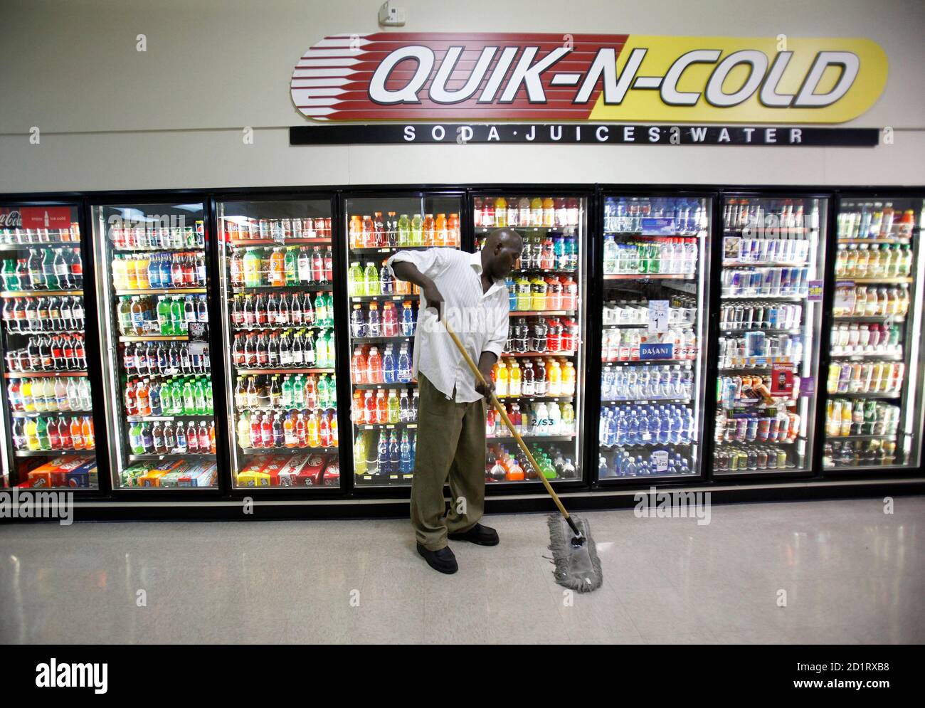 Frederick Wilson mops the floors at a gas station where he works nightly,  taking out the trash and mopping the floors in exchange for ten dollars  pay, in Grand Prairie, Texas June