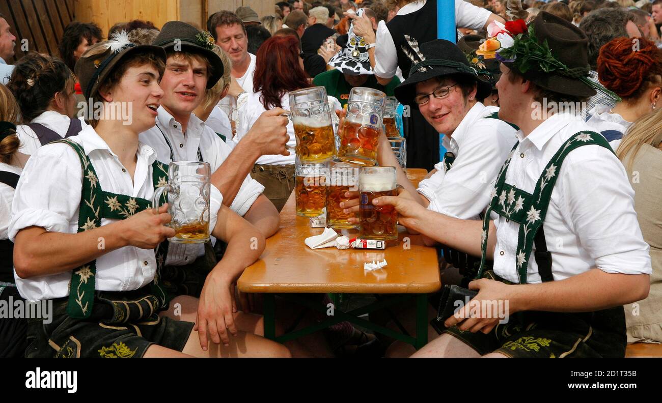 People in traditional Bavarian toast with beer at the world biggest beer festival Oktoberfest in Munich October 1, 2006. Germans, in party mood after the World Cup cheered by