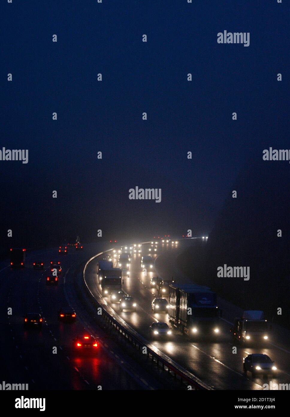 Traffic moves along the M40 at Lewknor, Oxfordshire, southern England December 1, 2006. Britain must make motorists pay for using its crammed roads to cut congestion, reduce pollution and stop the country grinding to a halt, a government-sponsored report on transport after 2015 said on Friday.  REUTERS/Eddie Keogh (BRITAIN) Stock Photo