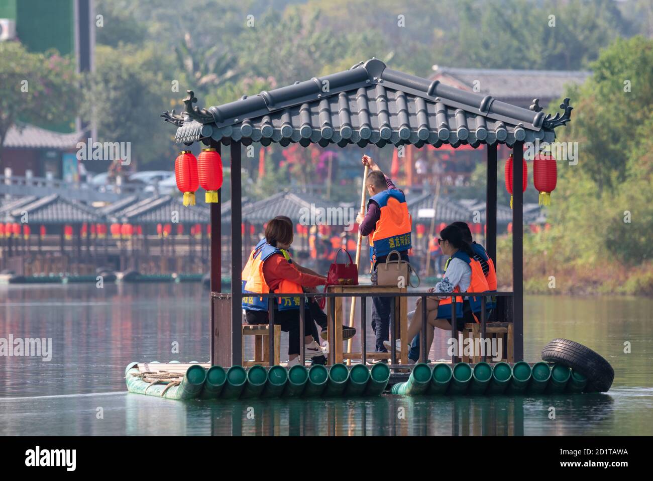 Yangshuo, Guilin, Guangxi province, China - November 10, 2019: Tourists on a bamboo raft with chinese lanterns on Li river. Stock Photo