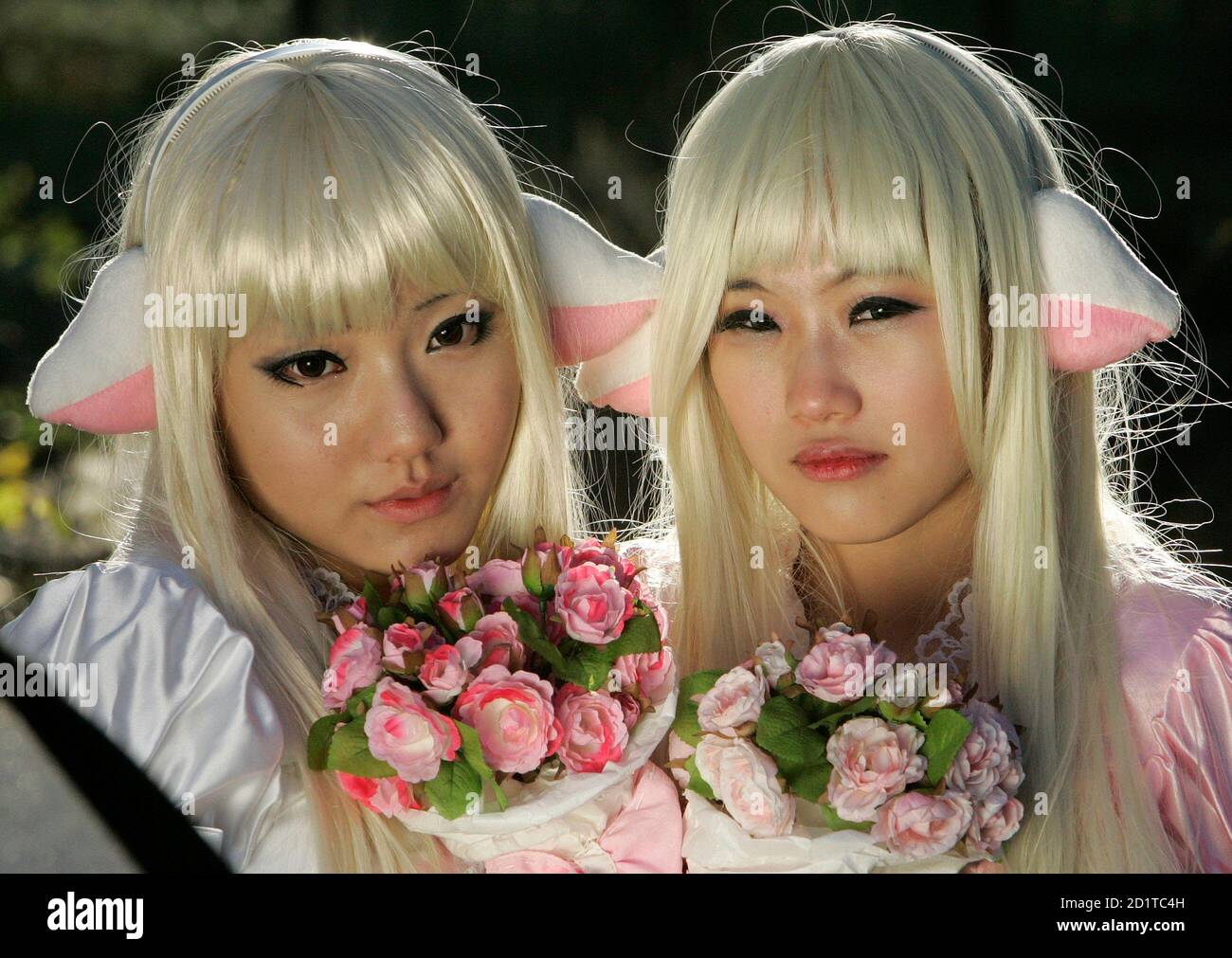 Lee Soo-hyun (L), 16, and Cho Hye-won, 16, pose as they dress up as a  character from the Japanese animation 'Chobits', during the monthly Seoul  Comic World event in Seoul November 15,