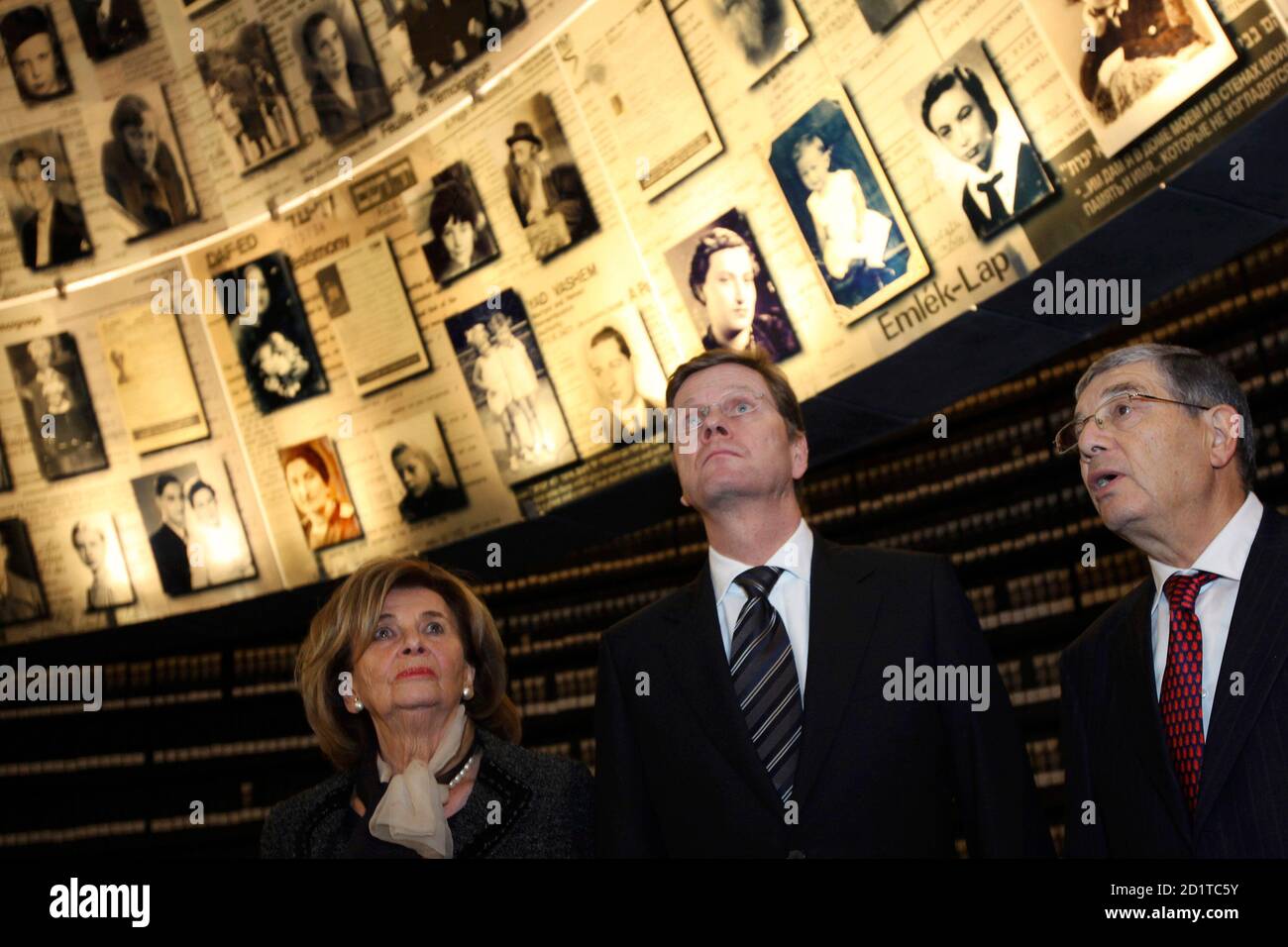 German Foreign Minister Dr. Guido Westerwelle (C), accompanied by Charlotte Knobloch (L), the President of the Central Council of German Jewry, and Director of Yad Vashem Avner Shalev (R), looks up at photos of slain Jews in the Hall of Names at the Yad Vashem Holocaust Memorial Museum in Jerusalem November 23, 2009.   REUTERS/David Silverman/Pool  (JERUSALEM POLITICS) Stock Photo