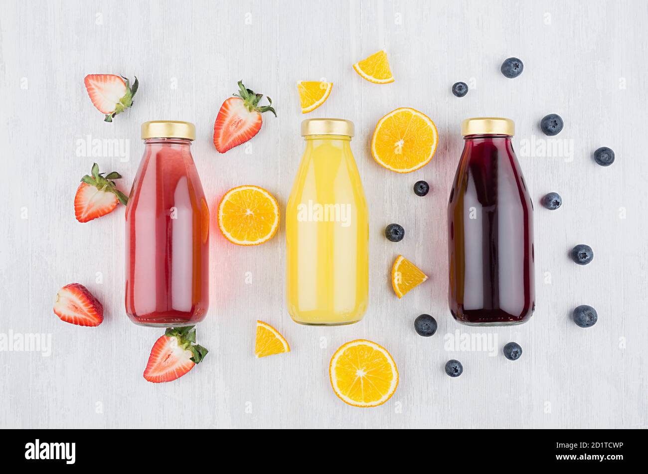 Download Organic Yellow Orange Pink Strawberry And Violet Blueberry Juices In Glass Bottles With Fruit Ingredients On White Wood Board Mock Up For Design Ad Stock Photo Alamy