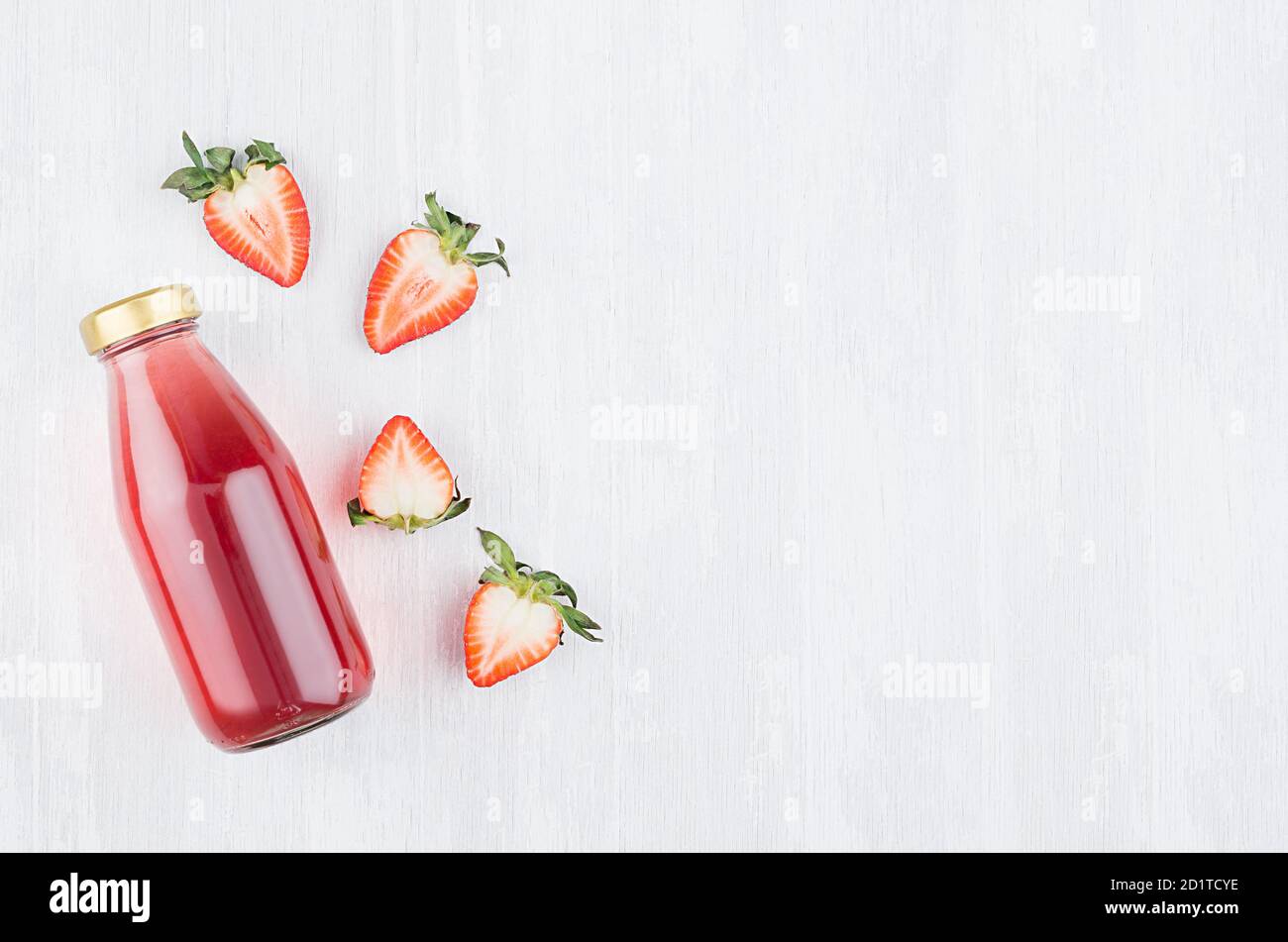 Download Bright Transparent Red Strawberry Juice In Glass Bottle As Template For Design And Advertising With Ingredients Slices Berry On White Wood Backgroun Stock Photo Alamy