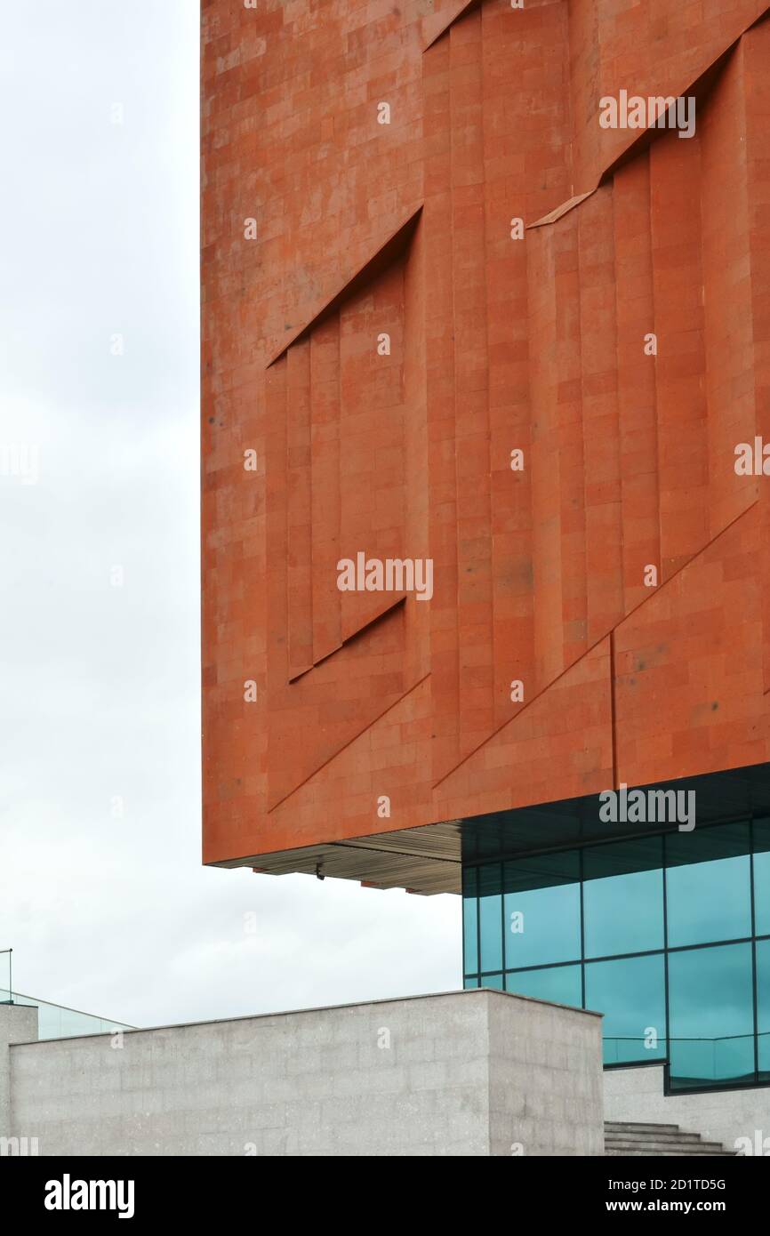 Fragment of the wall of a neo constructivism building made of red brick and glass. Stock Photo
