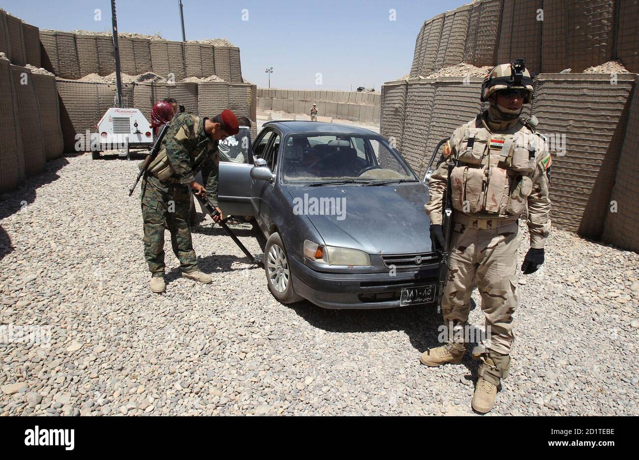 Iraqi security personnel search a vehicle at a checkpoint in the town of Jalawla, 115 km (71 miles) northeast of Baghdad June 28, 2010. Like other towns across Iraq's restive northern provinces of Diyala, Kirkuk and Nineveh, Jalawla defies the U.S. narrative of an end to combat operations next month under a plan to pull out of Iraq completely by the end of 2011. Picture taken June 28, 2010. REUTERS/Saad Shalash (IRAQ - Tags: CONFLICT MILITARY TRANSPORT SOCIETY) Stock Photo