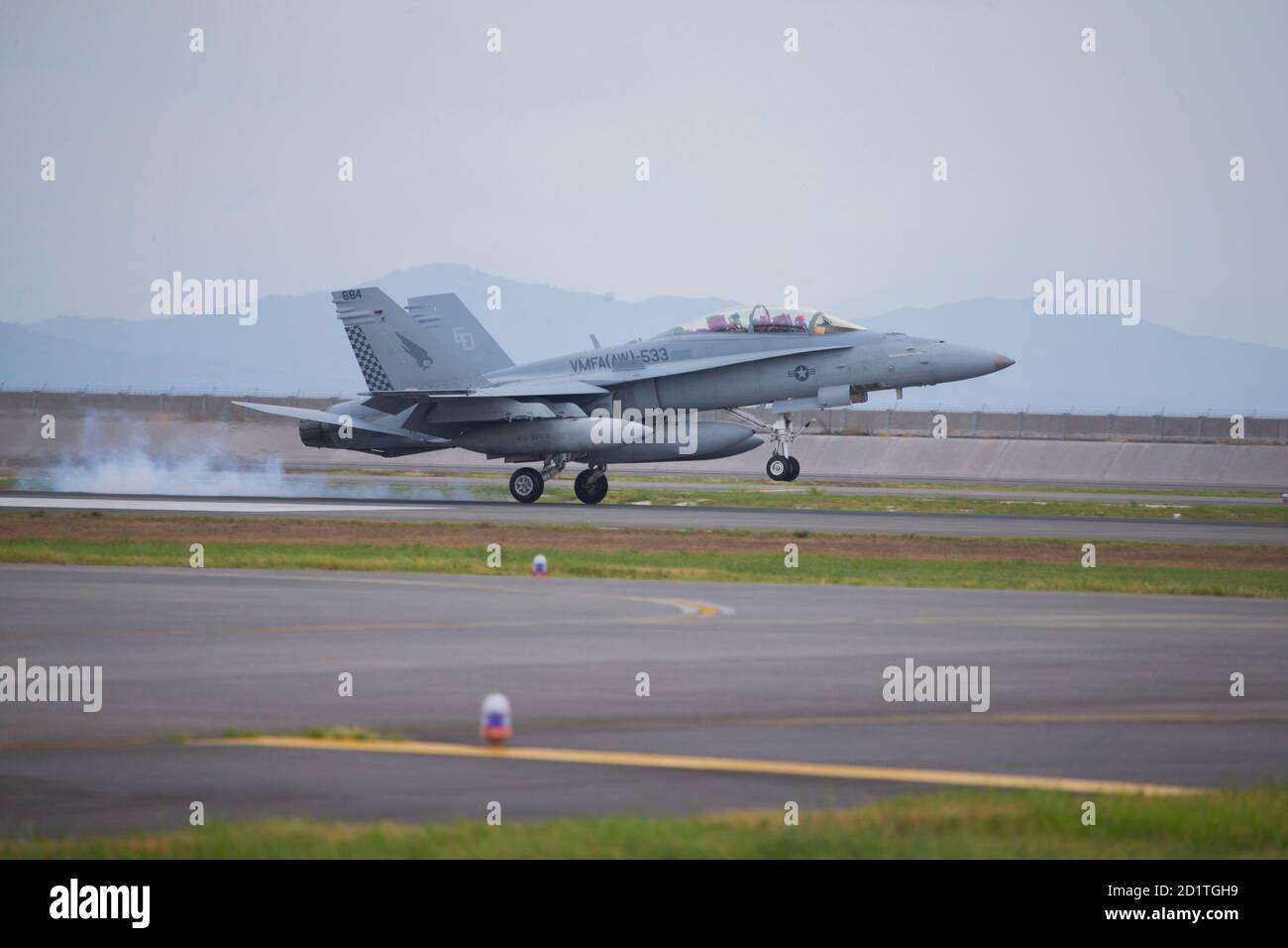 A U.S. Marine Corps F/A-18D Hornet with Marine All Weather Fighter Attack Squadron (VMFA (AW)) 533 lands at Marine Corps Air Station Iwakuni, Japan, Sept. 17, 2020. Marines with VMFA (AW) - 533, based out of Marine Corps Air Station Beaufort, South Carolina, take part in a rotational unit deployment program to supplement Marine Aircraft Group 12. The deployment enables MAG-12 to maintain its obligation to the Treaty of Mutual Cooperation and Security between Japan and U.S. while facilitating the safe transition for VMFA (AW) - 242 from F/A-18D Hornets to the F-35B Lightning II. (U.S. Marine Co Stock Photo