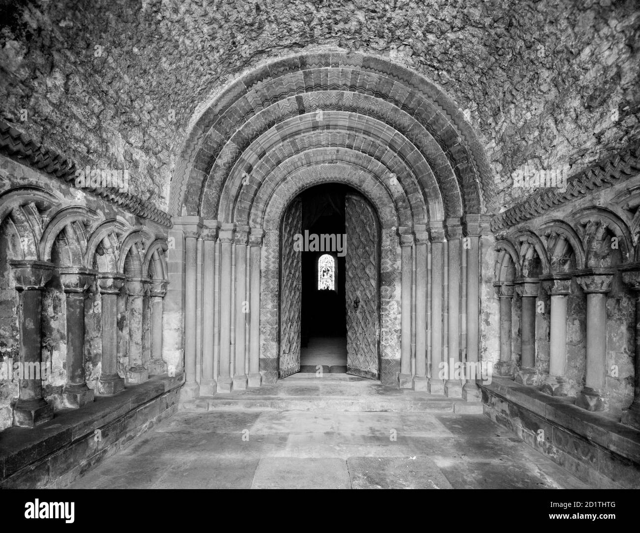 SOUTHWELL MINSTER, Nottinghamshire. The interior of the Norman north porch looking toward the elaborate zig-zag five order doorway with a tunnel vaulted roof. The minster was founded before the Conquest in the 950s, and afterwards became one the major churches of the region. Photographed by Henry Taunt (active 1860-1922). Stock Photo