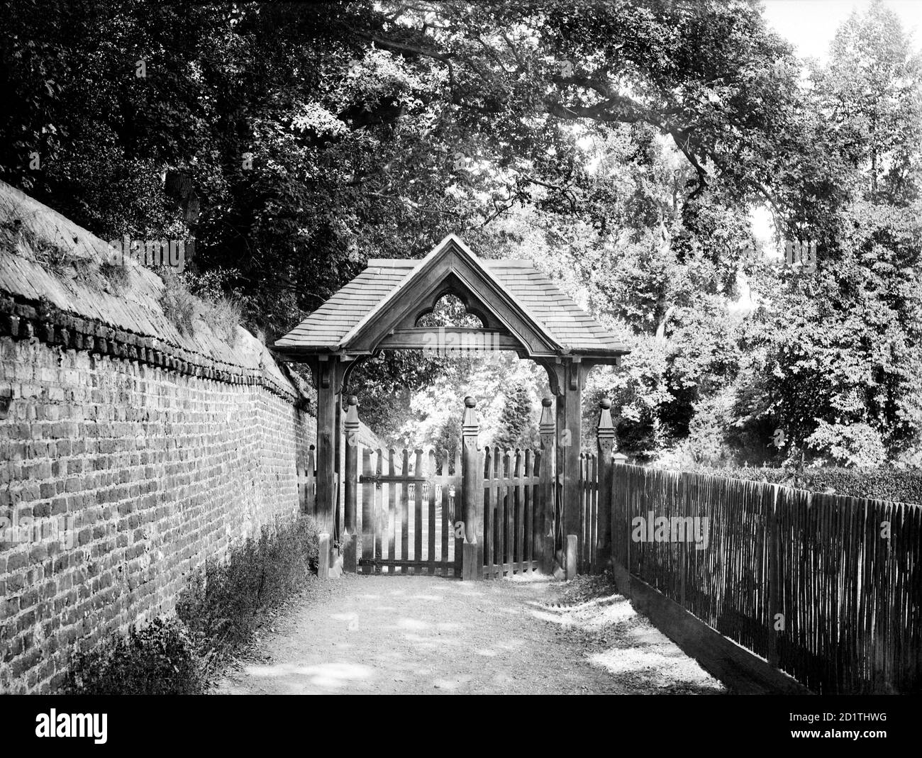 ST ANDREWS CHURCH, Sonning, Berkshire. The wooden lych gate of the church, built in the Victorian period, with a narrow lane behind. Photographed by Henry Taunt (active 1860 - 1922). Stock Photo
