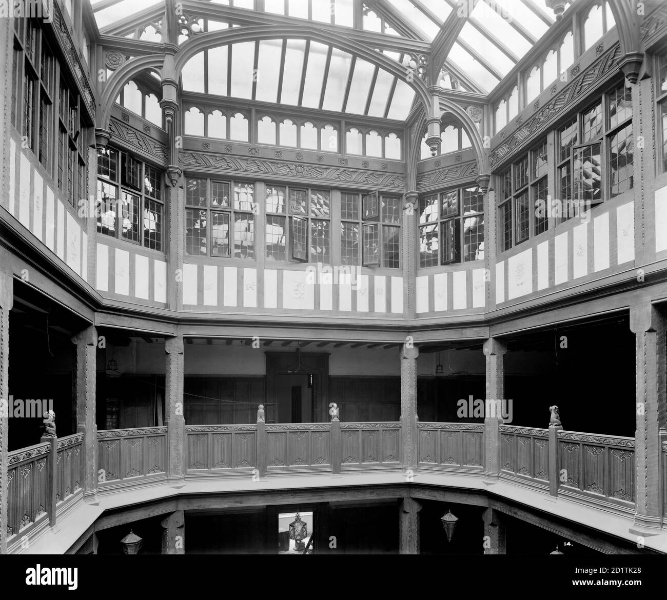 LIBERTY'S, Regent Street, London. Interior of Liberty's newly completed Arts and Crafts Tudor style department store, showing the gallery and light well. This extraordinary building was constructed in 1922-24 using timbers from HMS Hindustan and HMS Impregnable. It was a remarkable reaction to the early twentieth century vogue for stone dressed steel-framed buildings. Designed by Edwin T. Hall and E. Stanley Hall. This photograph was commissioned by Higgs and Hill, builders. Photographed by Bedford Lemere and Co. in 1924. Stock Photo