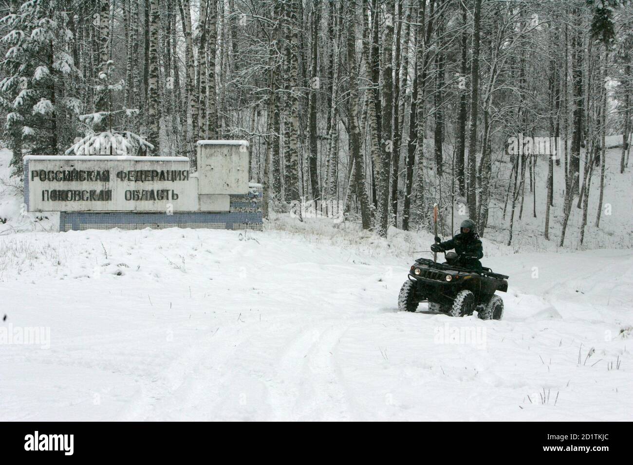 Latvian border guard Jurijs Kravcenko drives a quad during a patrol near the Latvia-Russia border in Opoli, 320 km (199 miles) from Riga November 12, 2007. Travellers will be able to drive from Riga to Rome or from Prague to Porto without once showing their passports after EU ministers agreed on Thursday to extend the bloc's border-free zone to nine more EU states from December 21. The Czech Republic, Estonia, Hungary, Lithuania, Latvia, Malta, Poland, Slovakia and Slovenia will join the so-called Schengen zone which encompasses 15 states. REUTERS/Ints Kalnins (LATVIA) Stock Photo