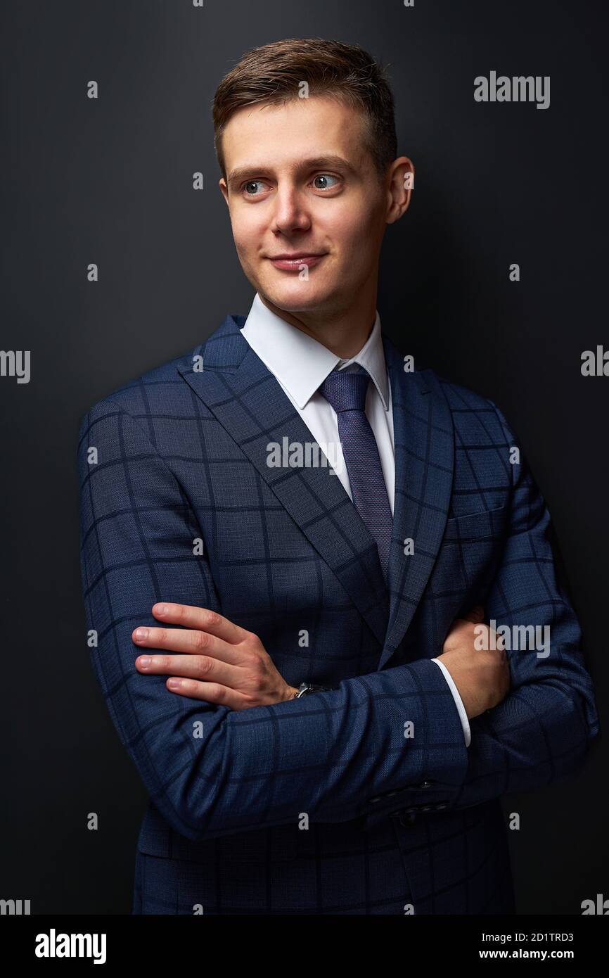 thoughtful young business man in classic black suit shirt posing ...