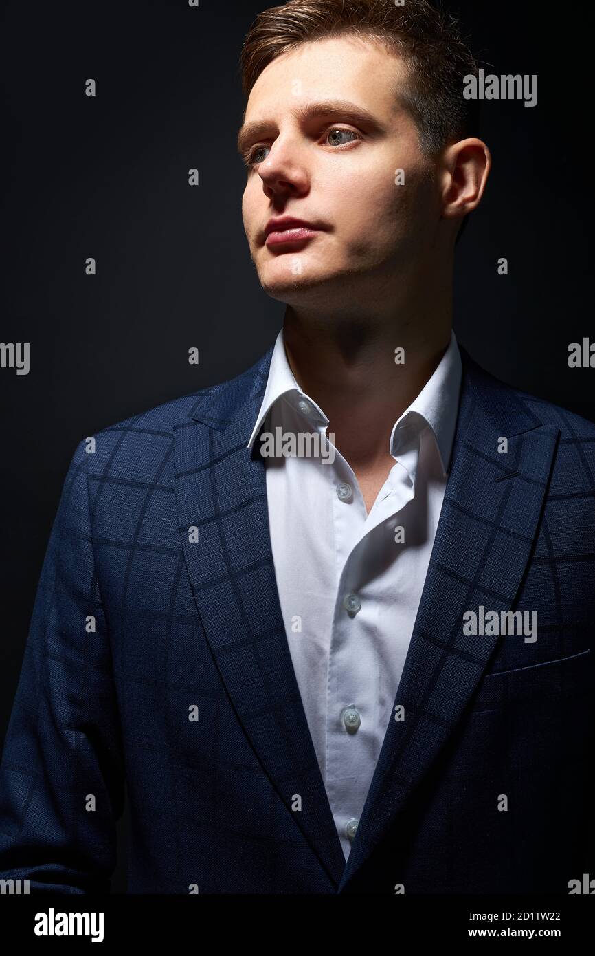 thoughtful young business man in classic black suit shirt posing ...