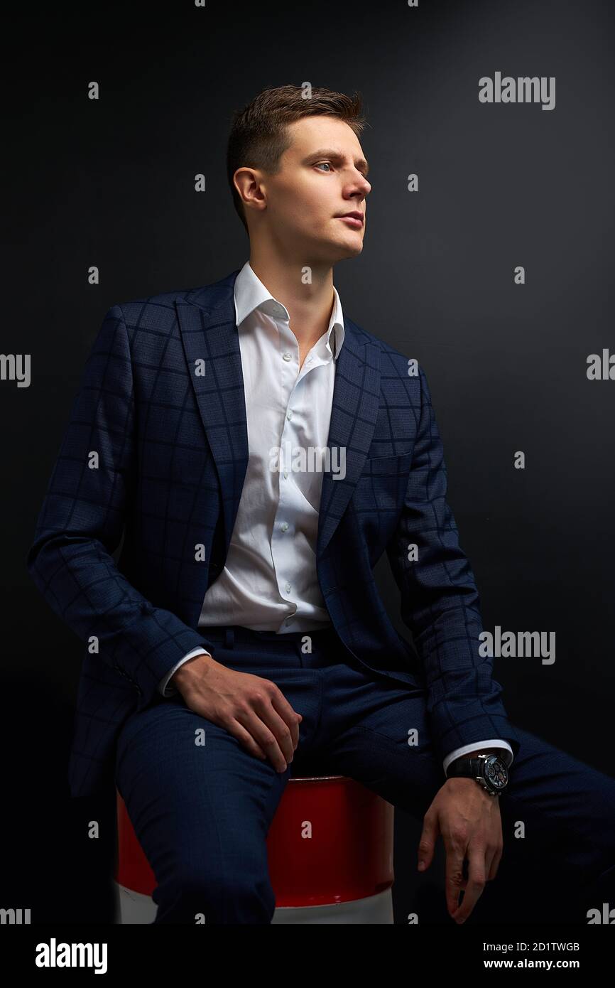 handsome business man owner of oil company sit on barrel posing ...