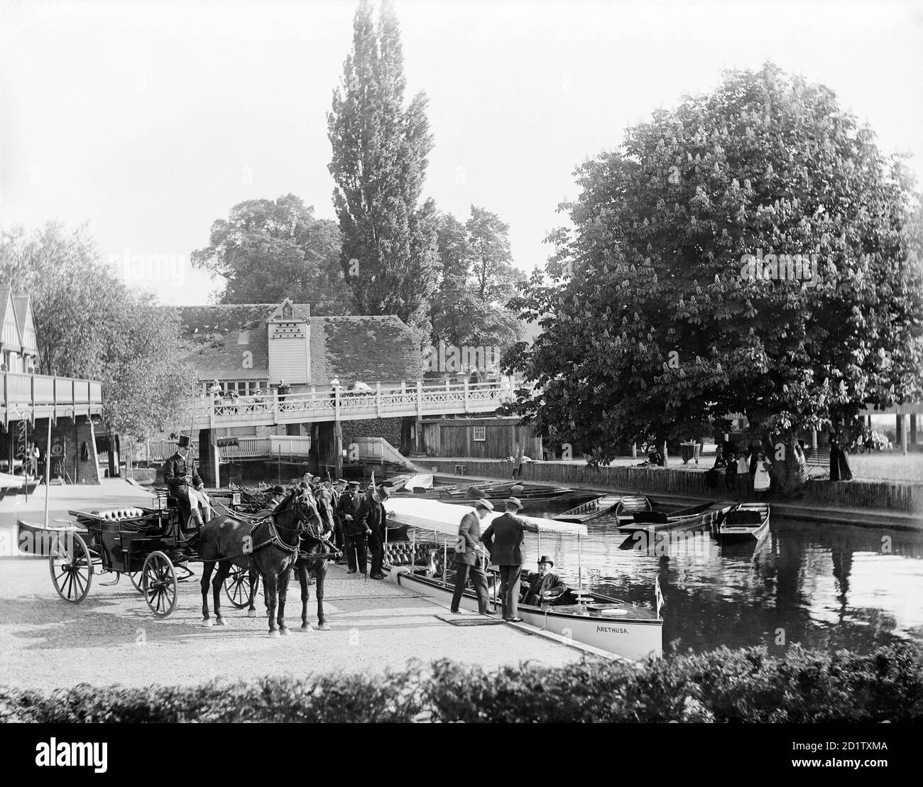 GORING, Oxfordshire. Edward, Prince of Wales sitting on the river boat 'Arethusa', moored along the banks of the River Thames, whilst other members of his party board. Photographed by Henry Taunt between 1860 and 1901. Stock Photo