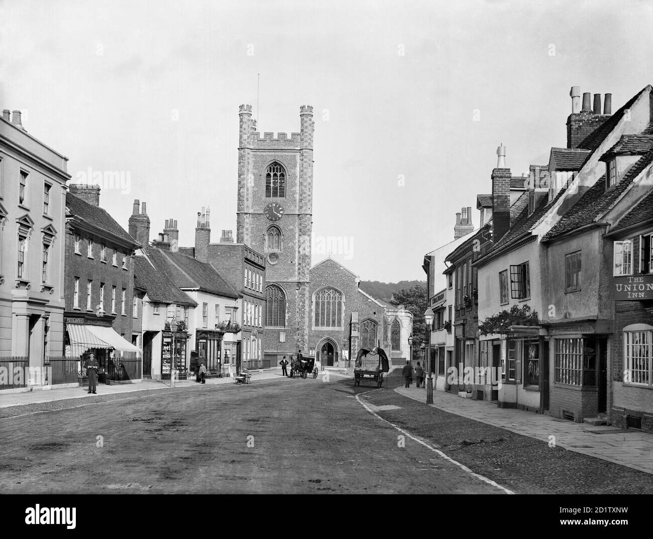 HENLEY-ON-THAMES, Oxfordshire. View of St Marys Church, looking down Hart Street towards the distinctive flint and stone chequer patterned church tower with polygonal angle buttresses, dating to the 16th century. On the right are some timber-framed town houses with dormer windows. Photographed by Henry Taunt in 1890. Stock Photo