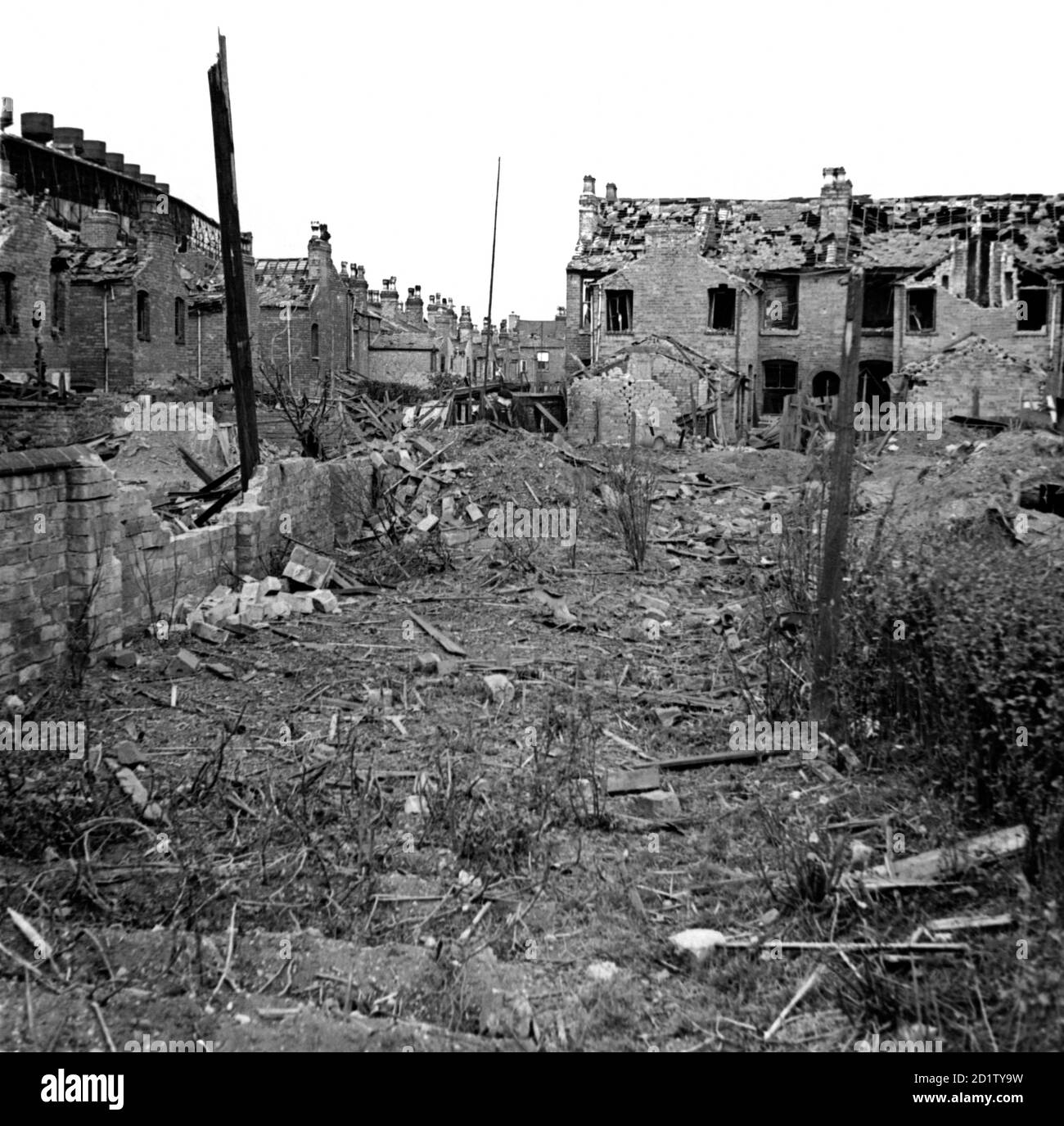 LONG ACRE, Nechells, Birmingham, West Midlands. The rear of Long Acre and Crompton Road showing bomb damage which included a direct hit on a shelter. Photographed by James Nelson, 29th July 1942. Stock Photo