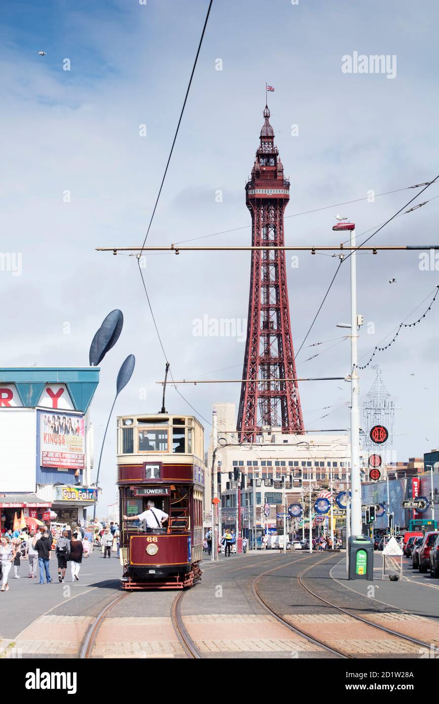 General view looking along the Promenade from the south, with a tram approaching and Blackpool Tower in the background, Blackpool, Lancashire, UK. Stock Photo