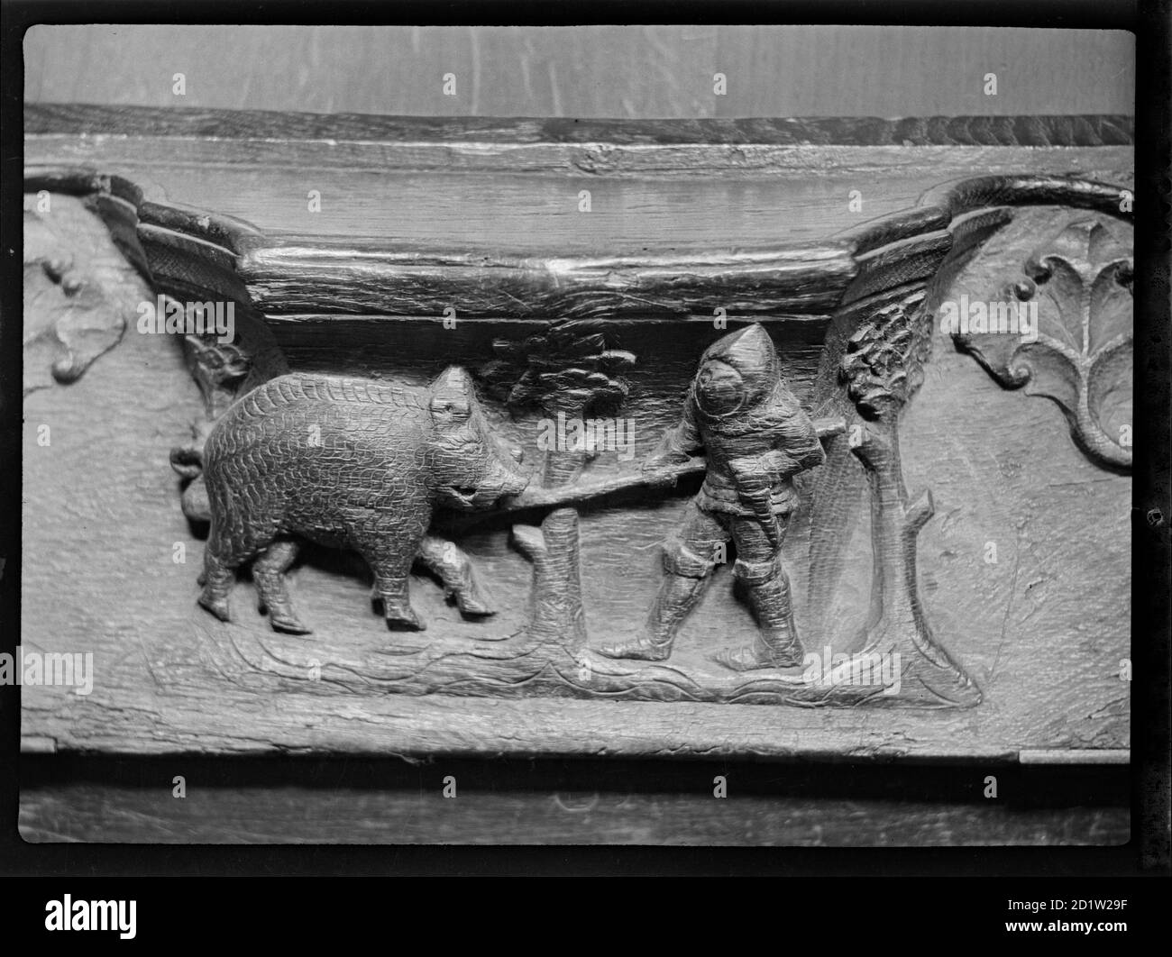 A misericord in St Mary's Church, depicting a knight with a spear attacking a wild boar, North Bar Within, Beverley, East Riding Of Yorkshire, UK. Stock Photo