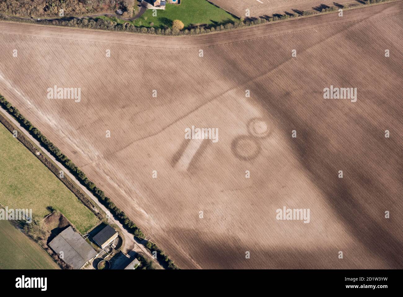 A long barrow soil mark and two bowl barrow soil marks on Houghton Down, near Danebury, Hampshire, 2018. Aerial view. Stock Photo