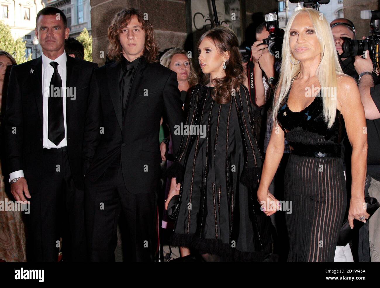 Italian designer Donatella Versace (R), her former husband Paul Beck (L),  son Daniel (2nd L) and daughter Allegra pose for photographers as they  arrive at La Scala Opera Theater for the ballet "