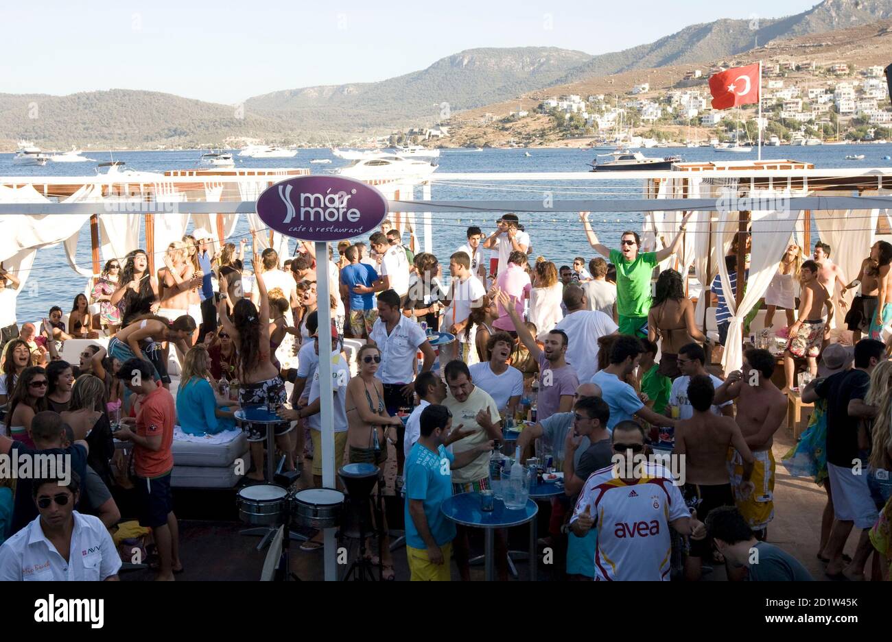 Young people dance and sing during a party in a beach club in Golturkbuku,  known for its luxury hotels, near the resort town of Bodrum on the  southwest Aegean coast of Turkey