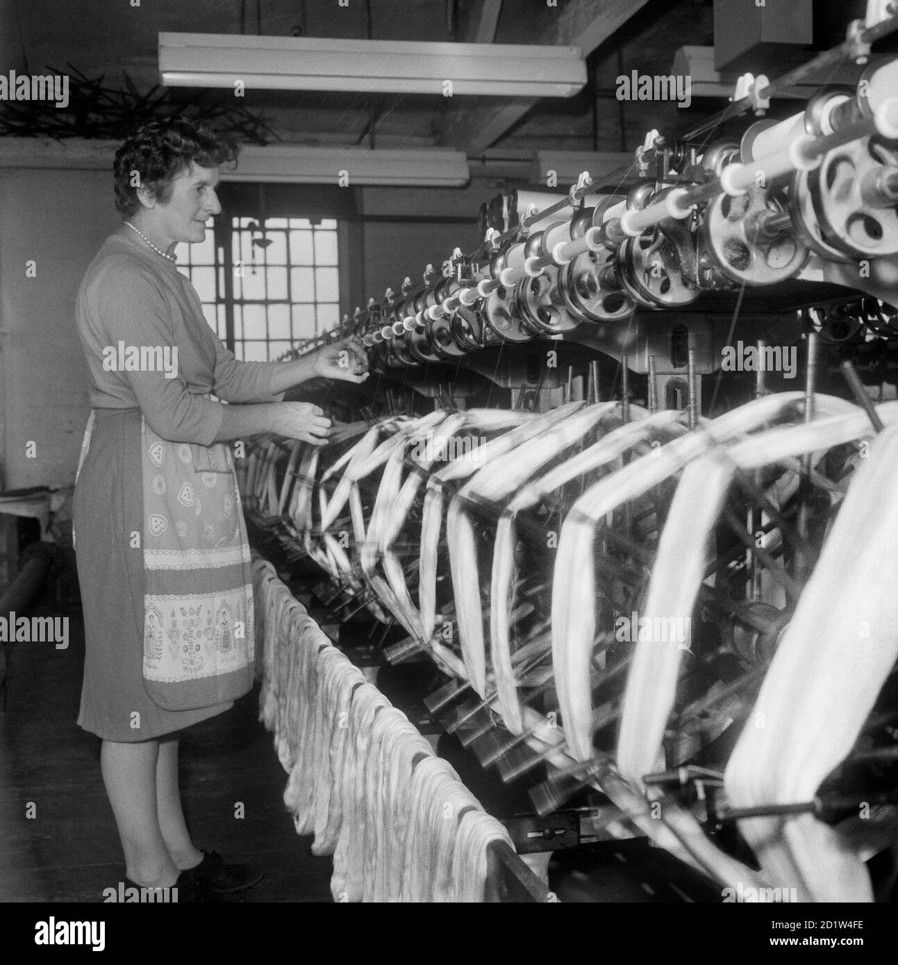 Woman working in a mill. Stock Photo