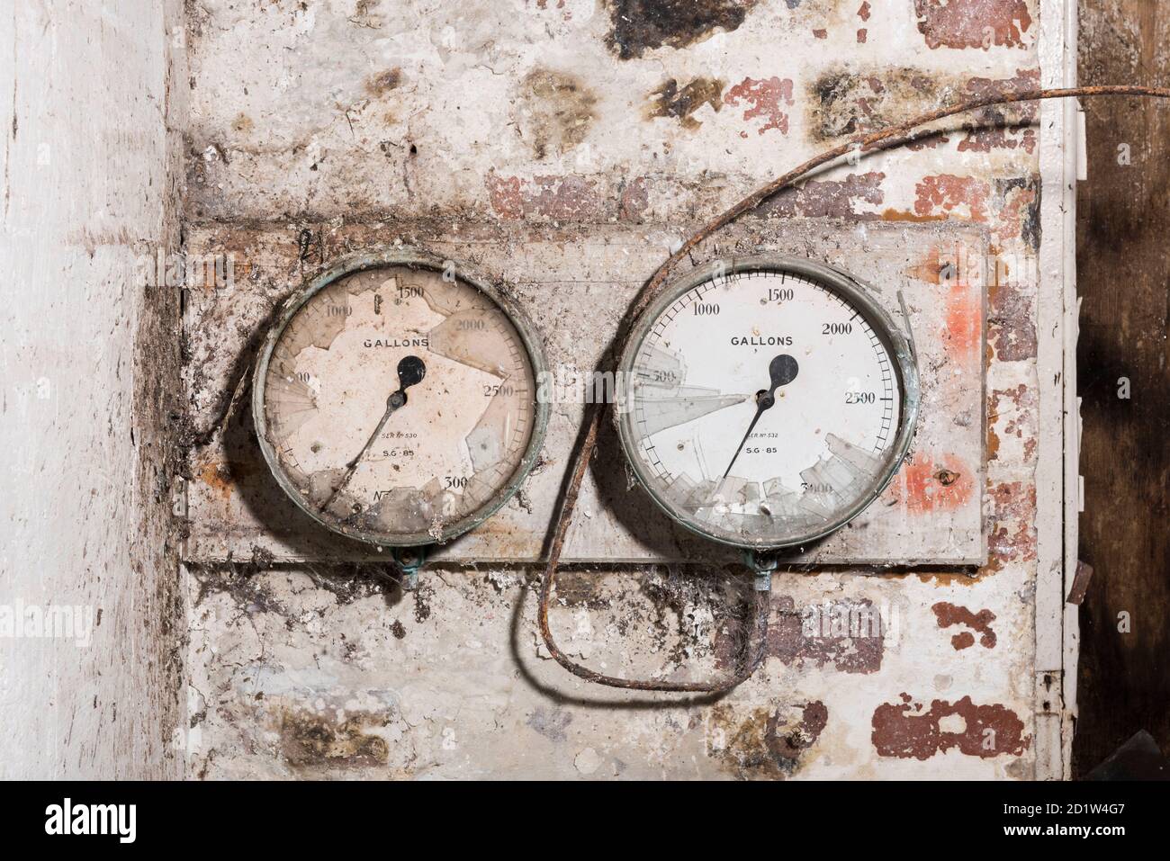 Close up of old and broken gauges on a brick wall. Stock Photo
