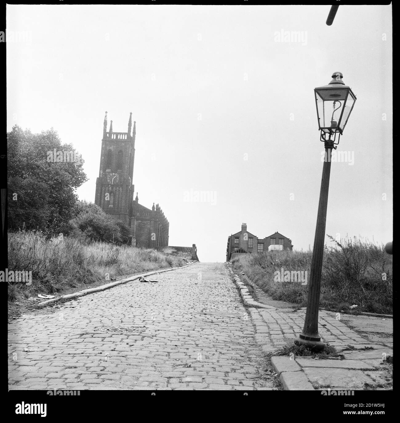 A view looking along St Mary's Street towards St Mary's Church with a lamp post in the foreground, Quarry Hill, Leeds, UK. Stock Photo