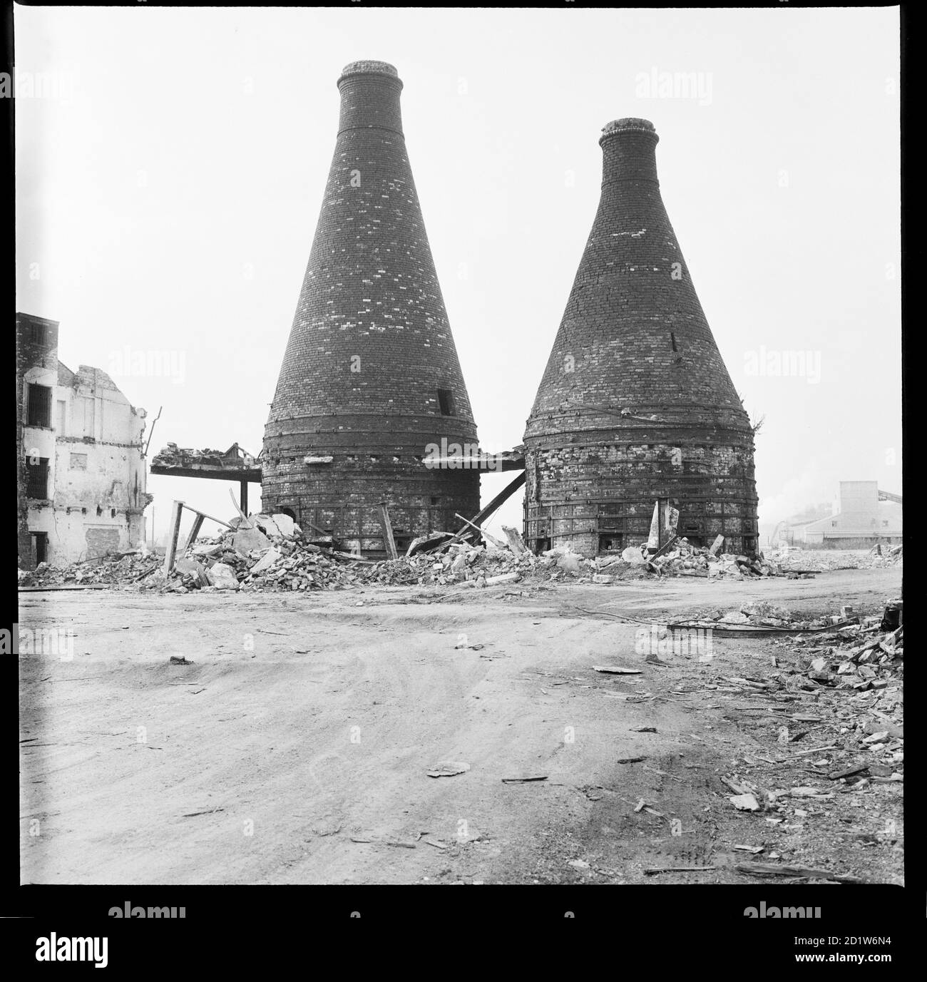 Two bottle kilns standing amidst the debris of the Josiah Wedgwood's Etruria Pottery Works during demolition, Etruria Road, Etruria, Stoke-on-Trent, Staffordshire, UK. Stock Photo